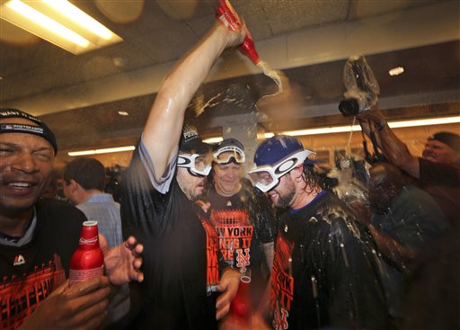 Members of the New York Mets celebrate a 3-2 win over the Los Angeles Dodgers in Game 5 of baseball's National League Division Series on Thursday, Oct. 15, 2015, in Los Angeles. (AP Photo/Lenny Ignelzi)