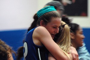 Falmouth Academy's Eliza Van Voorhis hugs teammate Jane Early. Van Voorhis led the Mariners with 18 points over Sturgis West last night to clinch a share of the Cape & Islands League championship title. Sean Walsh/Capecod.com sports