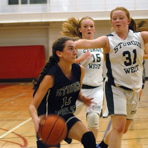 Sturgis East point guard Caroline Sullivan races to the basket as Sturgis West's Maggie Farley and Rachel Gardner try to stop her in last night's 42-37 win for the East. Sean Walsh.capecod.com sports Click photo to view gallery and order prints