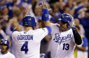 Kansas City Royals' Alex Gordon (4) and Salvador Perez (13) celebrate after scoring on a double by teammate Alex Rios during the fifth inning of Game 5 in baseball's American League Division Series against the Houston Astros, Wednesday, Oct. 14, 2015, in Kansas City, Mo. (AP Photo/Orlin Wagner)