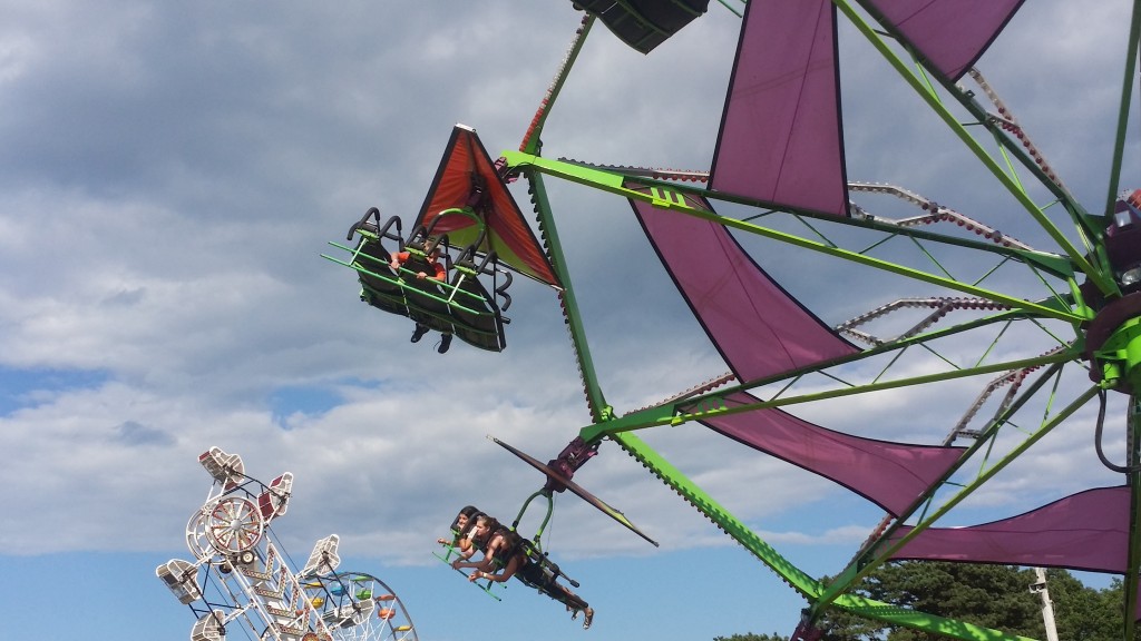 Kids take flight in one of the many midway rides at the Barnstable County Fair.