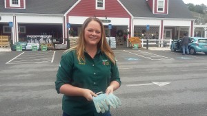 Agway of Dennis Store Manager Elizabeth Jenks holds the gloves found in the parking lot of the store on November 21