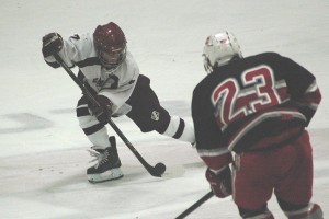 Falmouth High School hockey junior Ryan Pina takes the puck past Catholic Memorial's Jack Sullivan (23) in Saturday night's game at the Falmouth Ice Arena. Sean Walsh/CCBM Sports