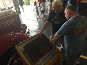 Attendees at Sunday's Hyannis Fire Department 9/11 Memorial Ceremony examine a piece of steel collected from the rubble created by the 2001 terror attacks.