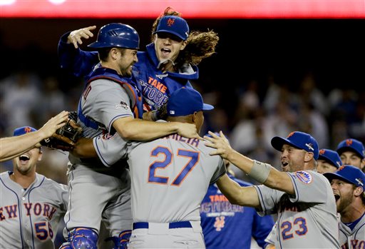 New York Mets starting pitcher Jacob deGrom, above right, catcher Travis d'Arnaud, left, and other Mets players celebrate a 3-2 win over the Los Angeles Dodgers in Game 5 of baseball's National League Division Series on Thursday, Oct. 15, 2015, in Los Angeles. (AP Photo/Alex Gallardo)