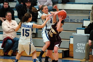 Krystle and Amber DiBona (15) attacked Old Colony Voke's Kaitlin Medeiros in a stifling second half full court press in last night's 50-39 win for the host Rams. Sean Walsh/Capecod.com Sports