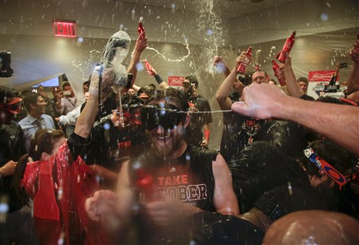 The Houston Astros celebrate in their locker room after defeating the New York Yankees 3-0 in the American League wild card baseball game Tuesday, Oct. 6, 2015, in New York. (AP Photo/Julie Jacobson)