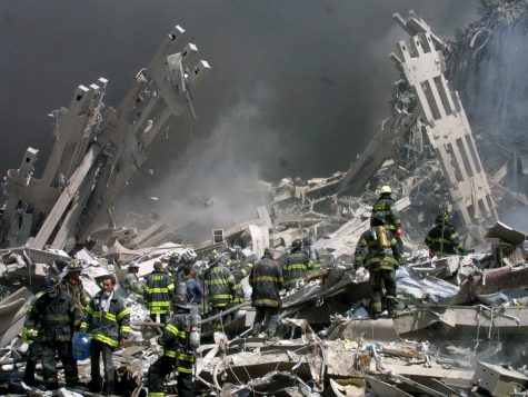 Firefighters make their way through the rubble after two airliners crashed into the World Trade Center in New York bringing down the landmark buildings Tuesday, Sept. 11, 2001. (AP Photo/Shawn Baldwin)