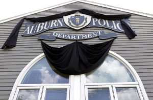 The sign is draped in black for slain Auburn Police Officer Ronald Tarentino outside the police station, Monday, May 23, 2016, in Auburn, Mass. (AP Photo/Elise Amendola)