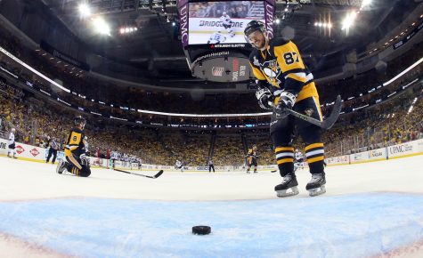 Pittsburgh Penguins' Sidney Crosby (87) retrieves the puck after the San Jose Sharks scored an empty-net goal during the third period in Game 5 of the NHL hockey Stanley Cup Finals on Thursday, June 9, 2016, in Pittsburgh. The Sharks won 4-2. (Bruce Bennett/Pool Photo via AP)