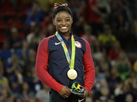 United States' Simone Biles smiles on the podium after winning vault gold during the artistic gymnastics women's apparatus final at the 2016 Summer Olympics in Rio de Janeiro, Brazil, Sunday, Aug. 14, 2016. (AP Photo/Dmitri Lovetsky)