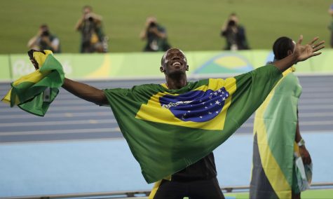Jamaica's Usain Bolt holds the flag of Brazil after winning the gold medal in the men's 4x100-meter relay final during the athletics competitions of the 2016 Summer Olympics at the Olympic stadium in Rio de Janeiro, Brazil, Friday, Aug. 19, 2016. (AP Photo/David Goldman)
