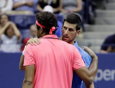 Novak Djokovic, of Serbia, talks with Jo-Wilfried Tsonga, of France, after Tsonga retired from the match in the quarterfinals of the U.S. Open tennis tournament, Tuesday, Sept. 6, 2016, in New York. (AP Photo/Darron Cummings)