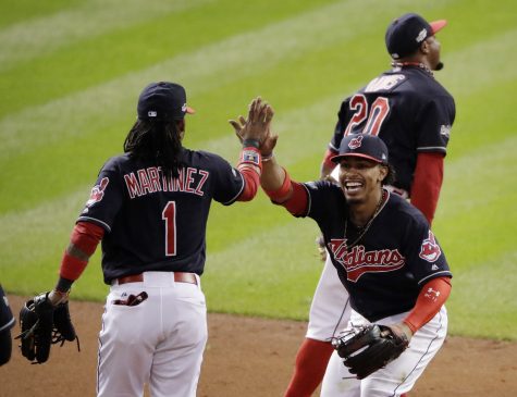 Cleveland Indians shortstop Francisco Lindor, right, celebrates with second baseman Michael Martinez after the Indians' 2-0 win against the Toronto Blue Jays in Game 1 of baseball's American League Championship Series in Cleveland, Friday, Oct. 14, 2016. (AP Photo/Charlie Riedel)