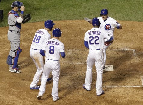 Chicago Cubs catcher Miguel Montero, right, celebrates after hitting a grand slam during the eighth inning of Game 1 of the National League baseball championship series against the Los Angeles Dodgers Saturday, Oct. 15, 2016, in Chicago. (AP Photo/David J. Phillip)