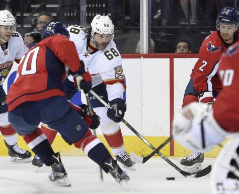 Florida Panthers right wing Jaromir Jagr (68), of the Czech Republic, skates with the puck against Washington Capitals defenseman Matt Niskanen (2) and Lars Eller (20) during the first period of an NHL hockey game, Saturday, Nov. 5, 2016, in Washington. (AP Photo/Nick Wass)