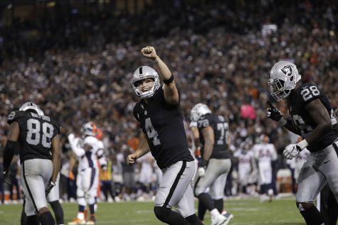 Oakland Raiders quarterback Derek Carr (4) celebrates after a touchdown run by Latavius Murray during the second half of an NFL football game against the Denver Broncos in Oakland, Calif., Sunday, Nov. 6, 2016. (AP Photo/Marcio Jose Sanchez)