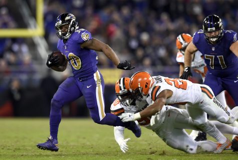 Baltimore Ravens running back Kenneth Dixon, left, rushes past Cleveland Browns strong safety Ibraheim Campbell (24) and outside linebacker Emmanuel Ogbah during the second half an NFL football game, Thursday, Nov. 10, 2016, in Baltimore. Baltimore won 28-7. (AP Photo/Gail Burton)