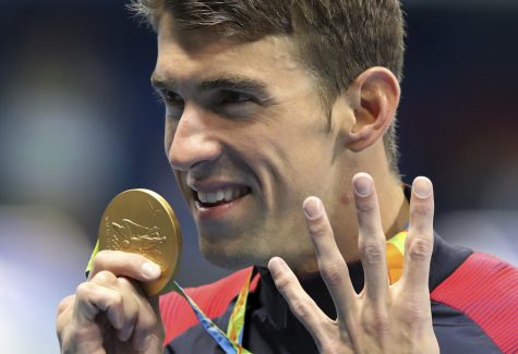FILE - In this Aug. 11, 2016 file photo, United States' Michael Phelps celebrates winning the gold medal in the men's 200-meter individual medley during the swimming competitions at the 2016 Summer Olympics, in Rio de Janeiro, Brazil. Phelps reiterated his retirement at USA Swimming's Golden Goggle awards on Mon. Nov. 21, 2016, telling reporters he had removed his name from a required drug testing system. (AP Photo/Lee Jin-man, File)