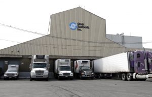 Trucks are parked at Stavis Seafoods, Inc. in Boston, Friday, March 13, 2015. (AP Photo/Elise Amendola)