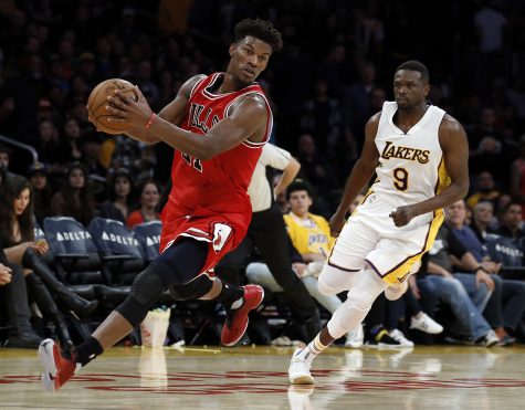 Chicago Bulls forward Jimmy Butler (21) catches a pass with Los Angeles Lakers forward Luol Deng (9) following during the second half of an NBA basketball game in Los Angeles, Sunday, Nov. 20, 2016. The Bulls won 118-110. (AP Photo/Alex Gallardo)