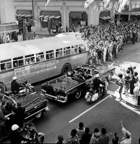 U.S. President John F. Kennedy and first lady Jacqueline Kennedy are riding in the backseat of an open limousine on Main Street at Ervay Street as the presidential motorcade approaches Dealey Plaza in downtown Dallas, Texas, on November 22, 1963. Only moments later the ride ends in the president's assassination. Texas Gov. John Connally, who will be wounded in the ambush attack, and his wife Nellie are seated in the limousine's jump seat. (AP Photo)