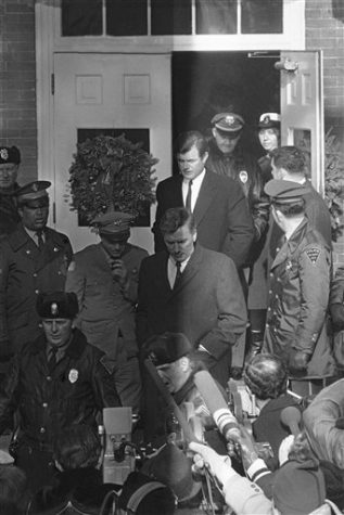 Sen. Edward M. Kennedy leaves Dukes County court house surrounded by police after appearing at inquest Jan. 6, 1970 into the death of Mary Jo Kopechne who died in car driven by the senator when it plunged off a bridge on Chappaquiddick Island at Martha's Vineyard into a pond on July 18, 1969. (AP Photo)