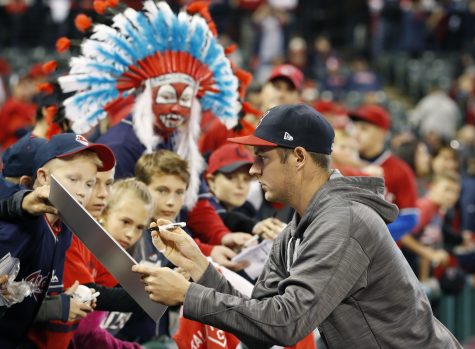 Cleveland Indians starting pitcher Trevor Bauer signs autographs before Game 1 of baseball's American League Championship Series against the Toronto Blue Jays in Cleveland, Friday, Oct. 14, 2016. (AP Photo/Gene J. Puskar)