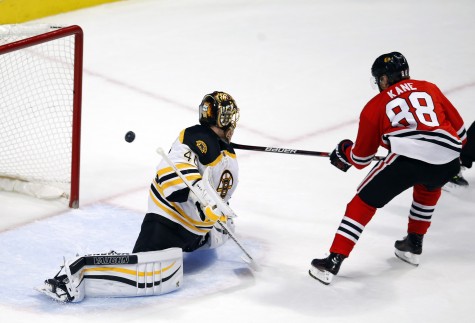 Chicago Blackhawks right wing Patrick Kane (88) scores a goal past Boston Bruins goalie Tuukka Rask (40) during the first period of an NHL hockey game Sunday, April 3, 2016, in Chicago. (AP Photo/Jeff Haynes)