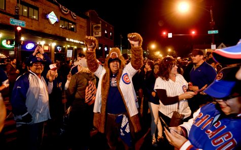 Chicago Cubs fans celebrate outside Wrigley Field after the Cubs defeated the Los Angeles Dodgers 5-0 in Game 6 of baseball's National League Championship Series, Saturday, Oct. 22, 2016, in Chicago. The Cubs advanced to the World Series. (AP Photo/Matt Marton)
