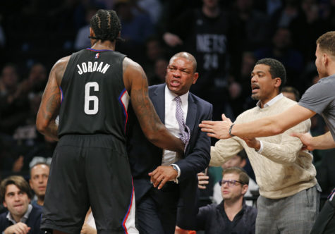 Los Angeles Clippers center DeAndre Jordan (6) and others move to restrain Los Angeles Clippers coach Doc Rivers, second from left, in overtime of an NBA basketball game against the Brooklyn Nets, Tuesday, Nov. 29, 2016, in New York. Rivers argued a referee's call for which he received a technical foul. Rivers objected to the technical and was ejected from the game for charging the referee. The Nets defeated the Clippers 127-122 in double overtime. (AP Photo/Kathy Willens)