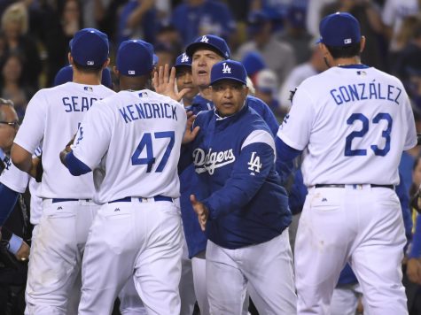 Los Angeles Dodgers manager Dave Roberts congratulates players after Game 3 of the National League baseball championship series against the Chicago Cubs Tuesday, Oct. 18, 2016, in Los Angeles. The Dodgers won 6-0 to take a 2-1 lead in the series. (AP Photo/Mark J. Terrill)