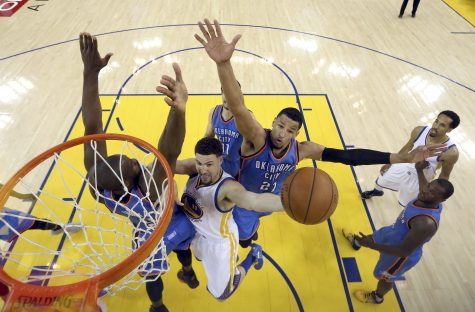 Golden State Warriors guard Klay Thompson, center, shoots between Oklahoma City Thunder forward Serge Ibaka, left, and guard Andre Roberson (21) during the first half of Game 7 of the NBA basketball Western Conference finals in Oakland, Calif., Monday, May 30, 2016. The Warriors won 96-88. (Ezra Shaw, Getty Images via AP, Pool)