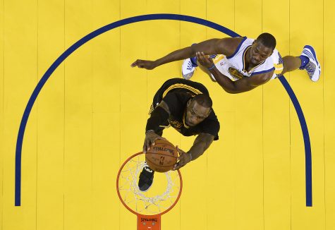 Cleveland Cavaliers forward LeBron James, bottom, dunks past Golden State Warriors forward Harrison Barnes during the second half of Game 5 of basketball's NBA Finals in Oakland, Calif., Monday, June 13, 2016. The Cavaliers won 112-97. (John G. Mabanglo, European Pressphoto Agency via AP, Pool)