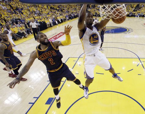 Golden State Warriors' Harrison Barnes (40) dunks past Cleveland Cavaliers' Kyrie Irving (2) during the second half in Game 1 of basketball's NBA Finals Thursday, June 2, 2016, in Oakland, Calif. (AP Photo/Marcio Jose Sanchez, Pool)