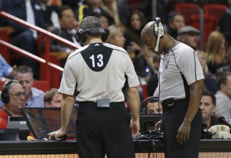 Officials Monty McCutchen (13) and Derrick Collins (11) watch a replay after Miami Heat center Hassan Whiteside elbowed San Antonio Spurs center Boban Marjanovic during the second half of an NBA basketball game, Tuesday, Feb. 9, 2016, in Miami. Whiteside was ejected with 9:35 left in the Spurs' 119-101 win at Miami on Tuesday night. He swung his right elbow after a free throw, smacking Marajonovic on the side of the face and knocking him backward. (AP Photo/Wilfredo Lee)