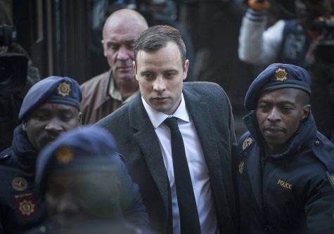 FILE - In this July 6, 2016, file photo, Oscar Pistorius, center, arrives at the High Court in Pretoria, South Africa, for a sentencing hearing for the murder of his girlfriend Reeva Steenkamp in his home on Valentine's Day 2013. The State is again challenging a ruling by Judge Thokozile Masipa against Pistorius in the High Court in Johannesburg, Friday, Aug. 26, 2016. (AP Photo/Shiraaz Mohamed, File)