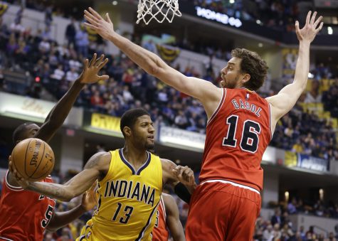 Indiana Pacers forward Paul George (13) makes a pass around Chicago Bulls center Pau Gasol (16) during the second half of an NBA basketball game in Indianapolis, Tuesday, March 29, 2016. The Bulls defeated the Pacers 98-96. (AP Photo/Michael Conroy)