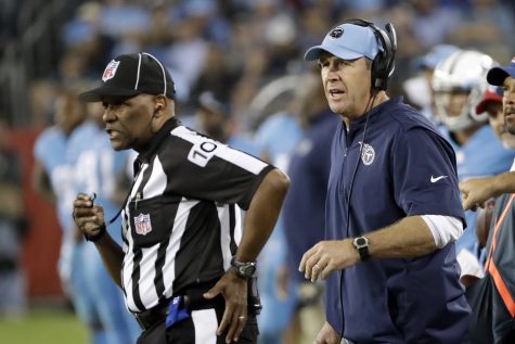 Tennessee Titans head coach Mike Mularkey, right, watches the action near head linesman Wayne  Mackie, left, in the second half of an NFL football game between the Titans and the Jacksonville Jaguars Thursday, Oct. 27, 2016, in Nashville, Tenn. (AP Photo/James Kenney)
