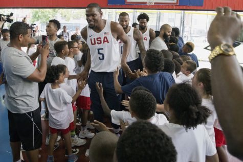 The U.S. men's Olympic basketball team player Kevin Durant greets kids who participated in a basketball clinic as he arrives for a news conference Monday, June 27, 2016, in New York. (AP Photo/Mary Altaffer)