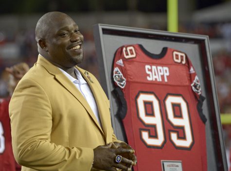 FILE - In this Nov. 11, 2013, file photo, former Tampa Bay Buccaneers player Warren Sapp smiles after being inducted in the Ring of Honor ceremony during halftime in an NFL football game between the Tampa Bay Buccaneers and the Miami Dolphins in Tampa, Fla. Sapp was bitten by a shark during a fishing trip off the Florida Keys on Wednesday, July 27, 2016. (AP Photo/Phelan M. Ebenhack, File)