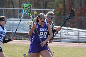 Bourne's Alex NIckerson (20) gets the ball jarred loose by Mashpee's Kelly Bohnenburger in yesterday's 13-13 tie. Phil Garceau Photo for Capecod.com Sports