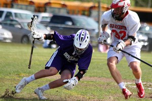 Bourne's Jake Girard loses his footing as the earth beneath him gives out in Thursday's 12-7 loss to Old ROchester in the MIAA D3 South boys' lacrosse quarterfinals. Phil Garceau/Capecod.com Sports 
