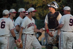 Notre Dame lefty Scott Tully hands the ball over to Harwich manager Steve Englert in the sixth inning last night vs. Brewster. Tully got the win. Sean Walsh/Capecod.com Sports