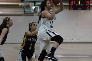 Falmouth High sophomore point guard Jenni DiCecco drives to the hoop past Nauset's Jenny Tulloch in last night's 50-29 Clipper victory to clinch the ACL championship title. Sean Walsh/Capecod.com sports