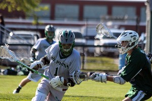 Dennis-Yarmouth's Andrew Jamiel spins past a Canton defender Wednesday afternoon in the Dolphins' first-ever boys' lacrosse postseason win. Phil Garceau/Capecod.com Sports