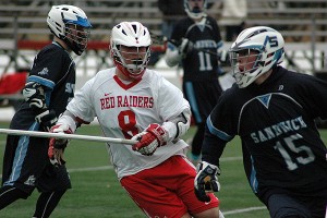Sandwich High's Brian Wahle wheels and deals as Barnstable's Josh Bestford tries to keep him from scoring position in yesterday's 9-8 win for the Blue Knights in Hyannis. Sean Walsh/Capecod.com Sports