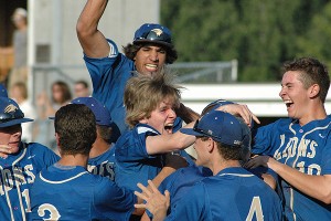 St. John Paul II sophomore pinch runner Pat Connolly is mobbed by his teammates after scoring the winning run in Wednesday's MIAA Div. 4 South Sectional Semifinal win over Monomoy at Wheaton College. Sean Walsh/Capecod.com Sports