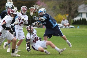 Sandwich High's Josh Souza delivers a big hit on Falmouth's Brennan McIntyre (44) during a scramble for a ground ball at midfield. Phil Garceau/Capecod.com Sports 