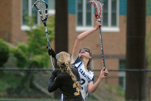 Nauset Regional High's Tess Ropulewis (3) and Sandwich High's Caroline McKenna battle for draw control in the Lady Knight's 14-9 tourney win Tuesday afternoon. Sean Walsh/Capecod.com Sports